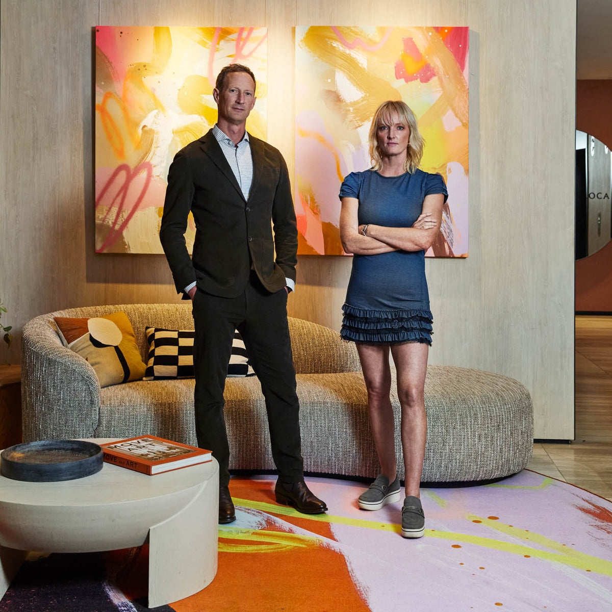 Geoffrey Carran and Rowena Martinich infront of Abstract artwork and Carpet at Rydges Melboune