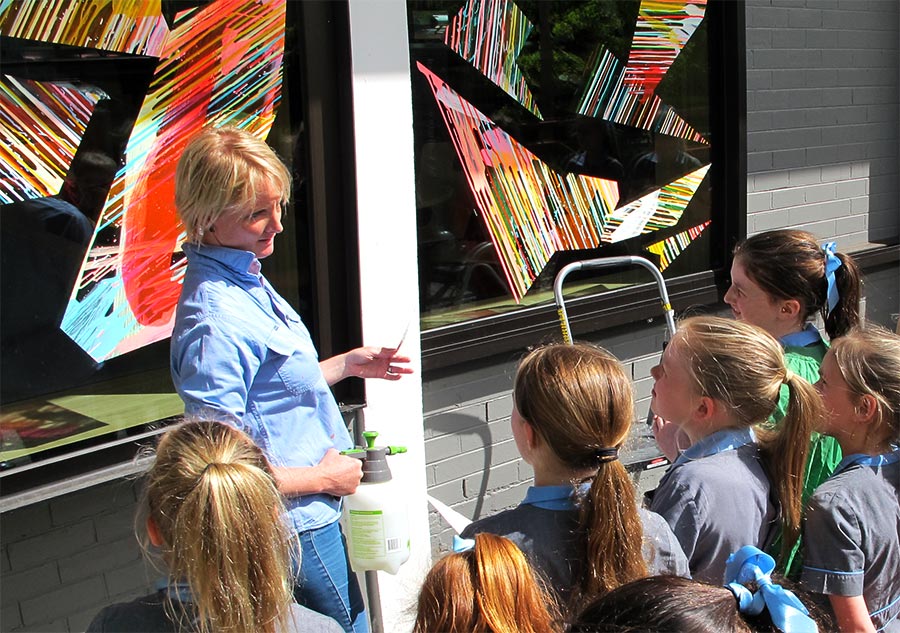 Rowena Martinich painting on site during a residency